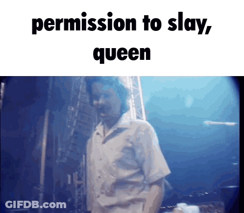 A Man Is Standing In Front Of A Blue Background With The Words Permission To Slay Queen Above Him GIF