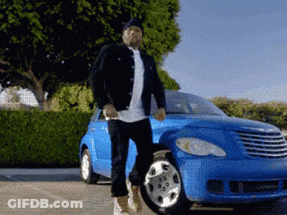 A Man Is Standing In Front Of A Blue Chrysler Car GIF