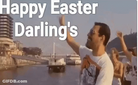 A Man Is Standing In Front Of A Body Of Water While A Group Of People Are Standing Behind Him . GIF