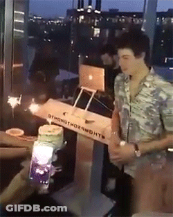 A Man Is Standing In Front Of A Box That Says ' Oymond Thornworth ' On It GIF