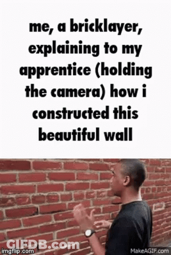 A Man Is Standing In Front Of A Brick Wall And Explaining To His Apprentice How He Built This Beautiful Wall . GIF