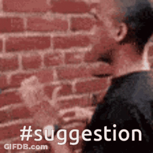 A Man Is Standing In Front Of A Brick Wall With The Words #Suggestion Written On It GIF