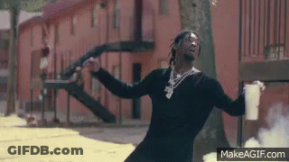 A Man Is Standing In Front Of A Building Holding A Gun And A Cup Of Coffee . GIF