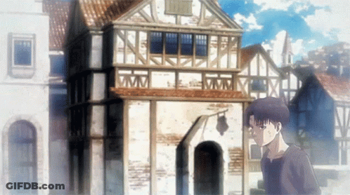 A Man Is Standing In Front Of A Building With A Clock On It GIF