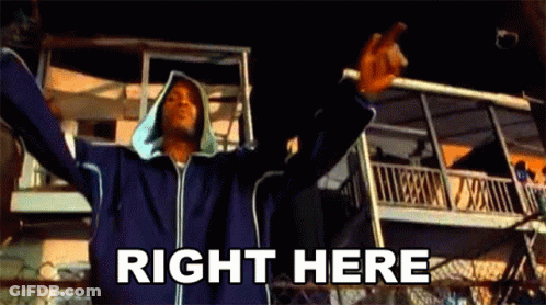 A Man Is Standing In Front Of A Building With His Arms Outstretched . GIF