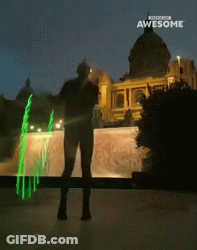 A Man Is Standing In Front Of A Building With The Words Awesome On The Bottom GIF