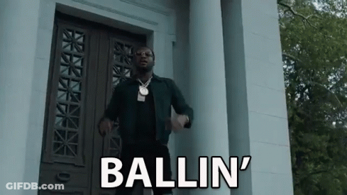 Man Standing In Front Of Building With Ballin On Door GIF