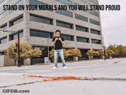A Man Is Standing In Front Of A Building With The Words Stand On Your Morals And You Will Stand Proud GIF