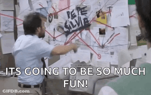 A Man Is Standing In Front Of A Bulletin Board With A Lot Of Papers On It And Pointing At It . GIF