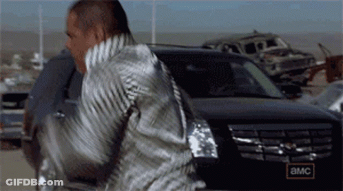 A Man Is Standing In Front Of A Car That Says Amc On The Side GIF