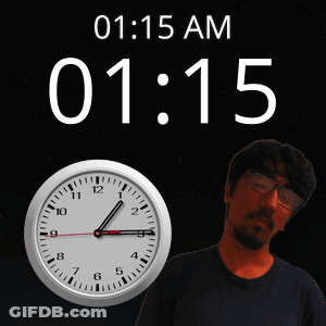 A Man Is Standing In Front Of A Clock That Says 1:15 GIF