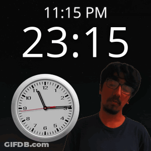 A Man Is Standing In Front Of A Clock That Says 23:15 GIF