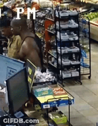 A Man Is Standing In Front Of A Computer In A Grocery Store With The Word Pm In The Corner . GIF