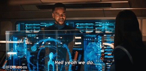 A Man Is Standing In Front Of A Computer Screen And Says Hell Yeah We Do GIF