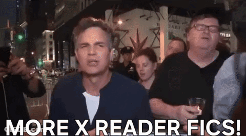 A Man Is Standing In Front Of A Crowd And Says More X Reader Fics ! GIF