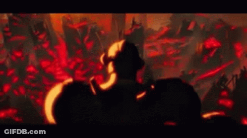 A Man Is Standing In Front Of A Crowd Of People In A Dark Room In A Video Game . GIF