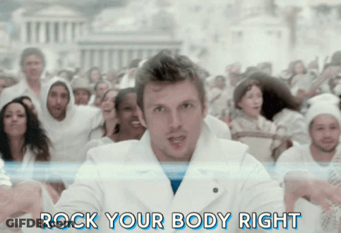 A Man Is Standing In Front Of A Crowd With The Words Rock Your Body Right Behind Him GIF