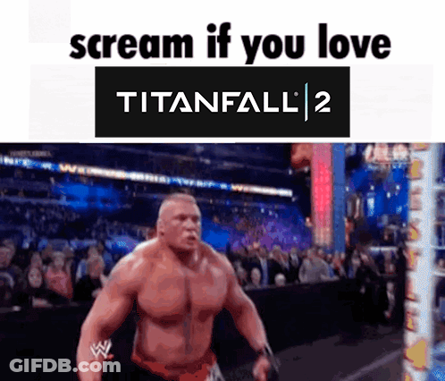 A Man Is Standing In Front Of A Crowd With The Words Scream If You Love Titanfall 2 Above Him . GIF