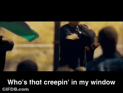 A Man Is Standing In Front Of A Crowd With The Words " Who 'S That Creepin ' In My Window " Below Him GIF