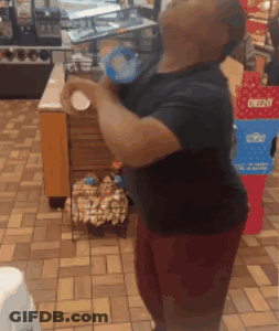 A Man Is Standing In Front Of A Display Of Oreos GIF