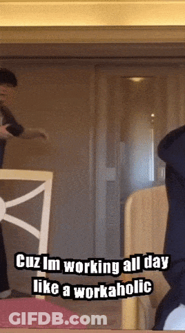 A Man Is Standing In Front Of A Door With The Words Cuz Im Working All Day Like A Workaholic GIF