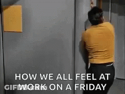 A Man Is Standing In Front Of A Door With The Words `` How We All Feel At Work On A Friday '' Written On It . GIF