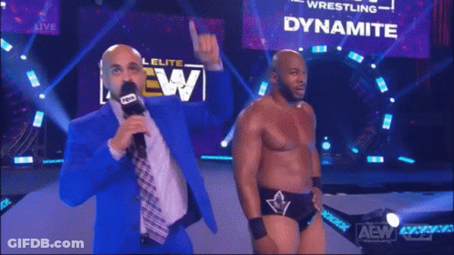 A Man Is Standing In Front Of A Dynamite Sign GIF