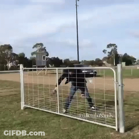 A Man Is Standing In Front Of A Fence That Says ' Glenn ' On It GIF