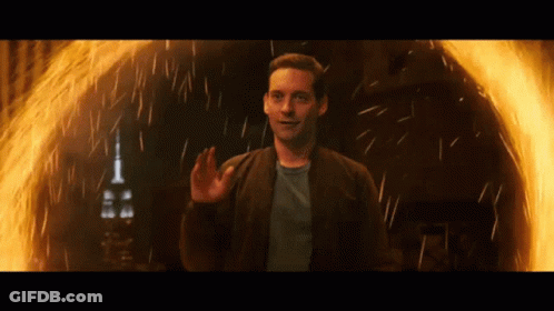 A Man Is Standing In Front Of A Fire Ring GIF