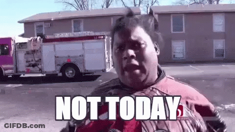 A Man Is Standing In Front Of A Fire Truck With The Words `` Not Today '' Written On His Chest . GIF