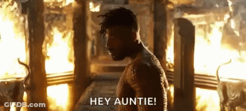 A Man Is Standing In Front Of A Fire With The Words `` Hey Auntie '' . GIF