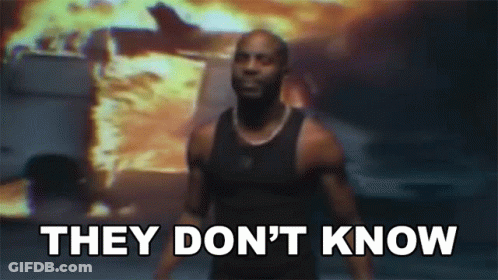 A Man Is Standing In Front Of A Fire With The Words " They Don 'T Know " GIF