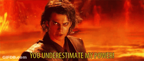 A Man Is Standing In Front Of A Fire With The Words `` You Underestimate My Power '' Written Above Him . GIF