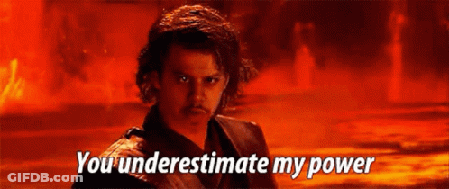 A Man Is Standing In Front Of A Fire With The Words `` You Underestimate My Power '' Written On The Screen . GIF