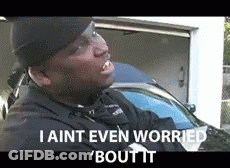 A Man Is Standing In Front Of A Garage With The Words I Aint Even Worried Bout It GIF