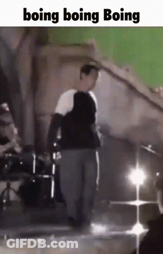 A Man Is Standing In Front Of A Green Screen With The Words Boing Boing Boing GIF