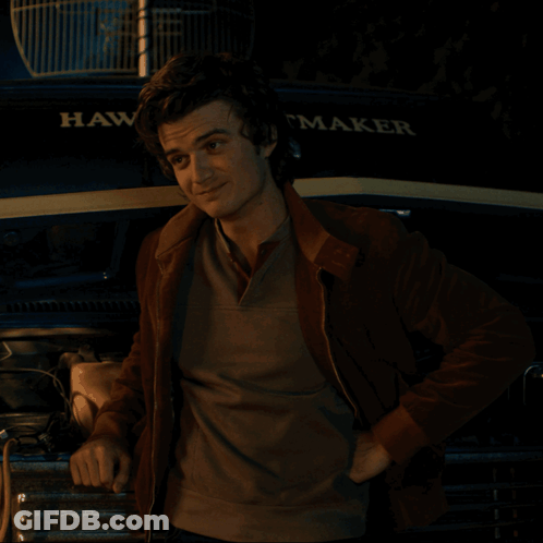 A Man Is Standing In Front Of A Hawk Maker Truck GIF