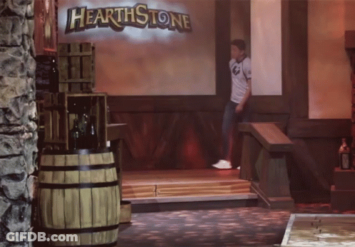 A Man Is Standing In Front Of A Hearthstone Sign GIF
