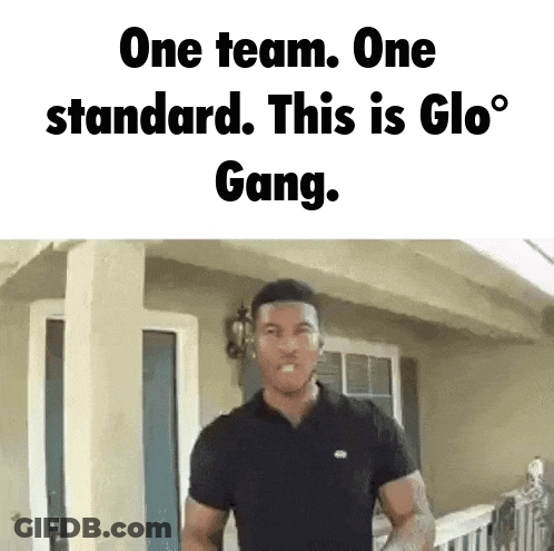 A Man Is Standing In Front Of A House With The Words One Team One Standard This Is Glo Gang GIF