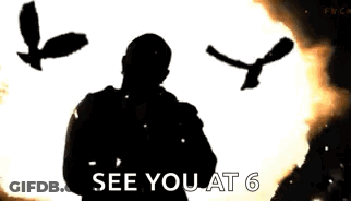 A Man Is Standing In Front Of A Huge Explosion With A Bird Flying In The Background . GIF