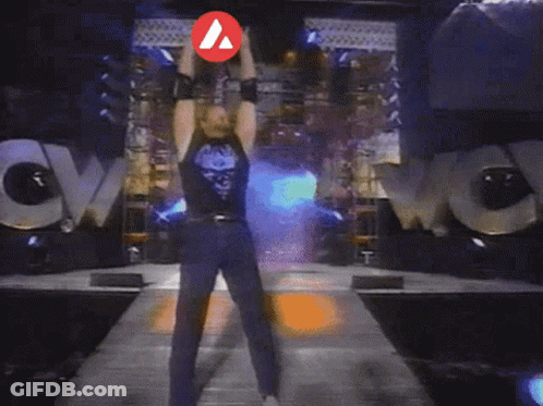A Man Is Standing In Front Of A Huge Explosion With A Red Arrow Pointing To His Chest GIF