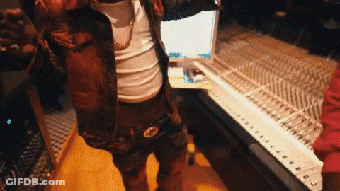 A Man Is Standing In Front Of A Keyboard In A Room GIF