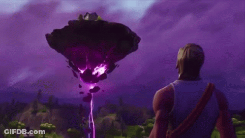 A Man Is Standing In Front Of A Large Purple Object In The Sky . GIF