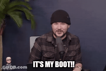A Man Is Standing In Front Of A Microphone And Says It 'S My Boot . GIF