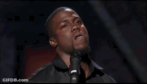 A Man Is Standing In Front Of A Microphone And Singing Into It . GIF