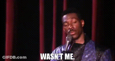 A Man Is Standing In Front Of A Microphone With The Words `` Wasn 'T Me '' Written On It . GIF
