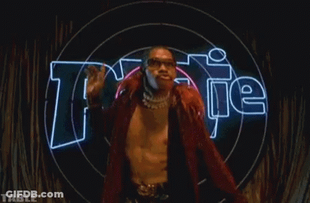 A Man Is Standing In Front Of A Neon Sign That Says " Table " GIF