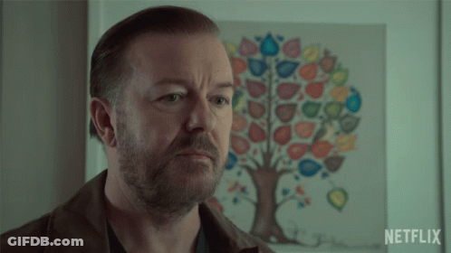 A Man Is Standing In Front Of A Netflix Poster GIF