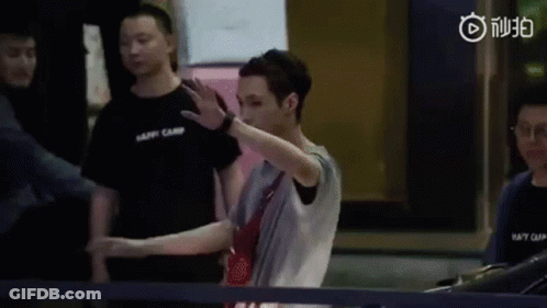 A Man Is Standing In Front Of A Ping Pong Table Making A Funny Face . GIF