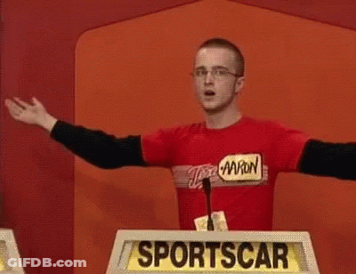 A Man Is Standing In Front Of A Podium That Says Sportscar GIF